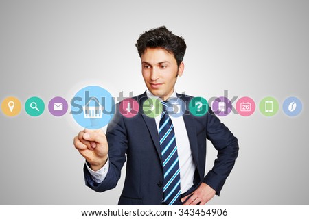Business man choosing shopping cart icon for online shopping on a touchscreen