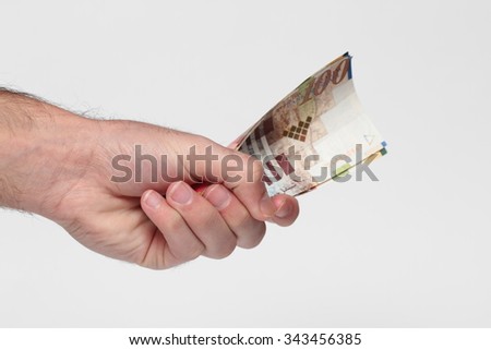 Hand holding banknotes on a white background (Israeli banknotes  , USD )