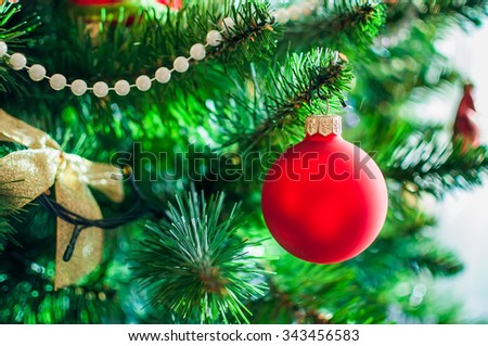 Decorated beautiful Christmas tree with big red ball