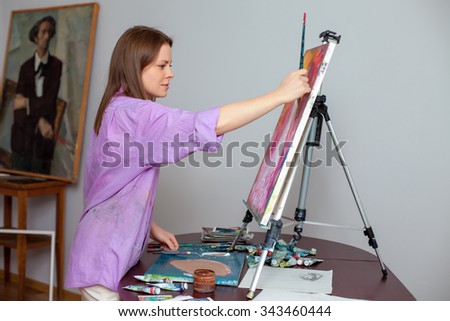 Creative female artist  drawing the picture in the studio
