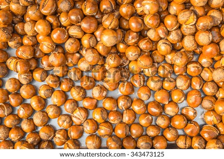 Delicious roasted chestnuts on the wooden background.