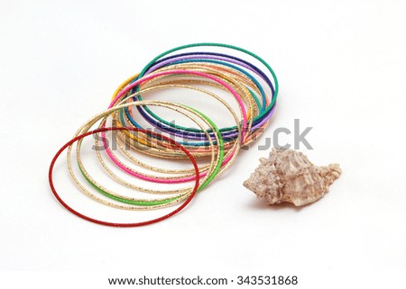Bracelets and shell on white background