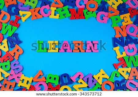 Learn written by plastic colorful letters on a blue background