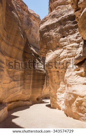A winding gorge through the desert on a sunny day outside of Petra in Jordan
