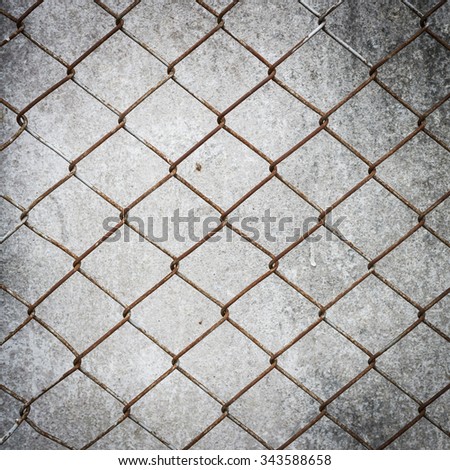 rusty wire fence with cement wall grunge background