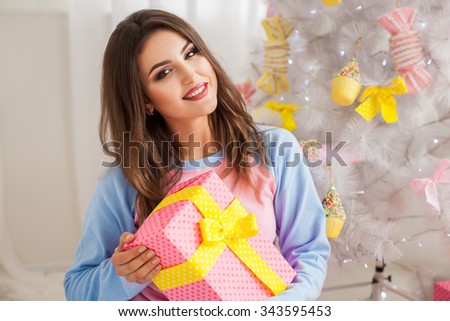 Young girl with christmas present close-up picture