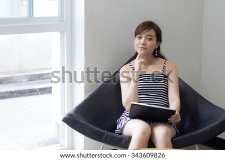 Portrait of thai adult businesswoman beautiful girl using her tablet.
