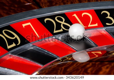 Classic casino roulette wheel with black sector twenty-eight 28 and white ball and sectors 29, 7, 12, 35 Royalty-Free Stock Photo #343620149