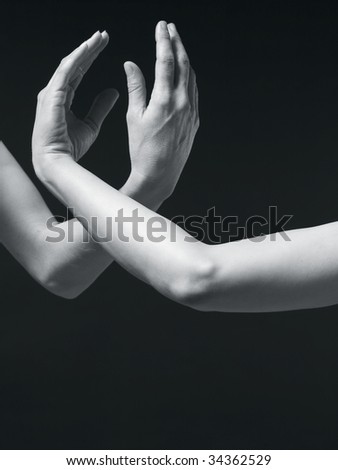 Monochrome image of two hands forming a link