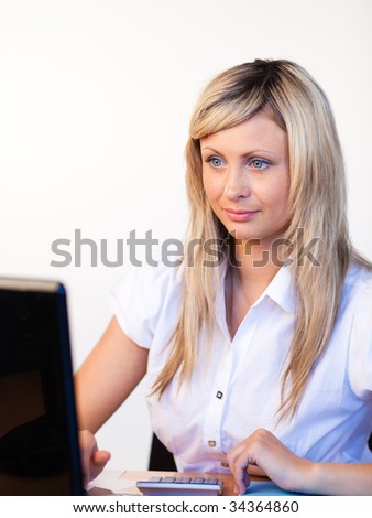 Beautiful businesswoman in office using a laptop
