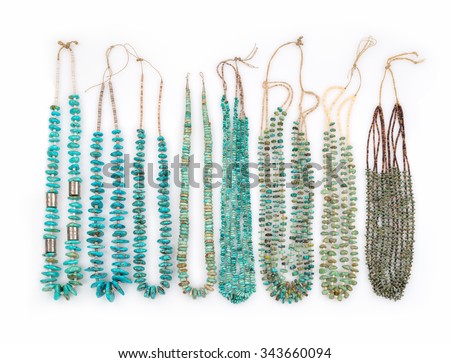 A Collection of Vintage Turquoise Native American Necklaces with Silver Beads and Tortoise Shell Heishe Beads which are strung on Catgut, on a white background.