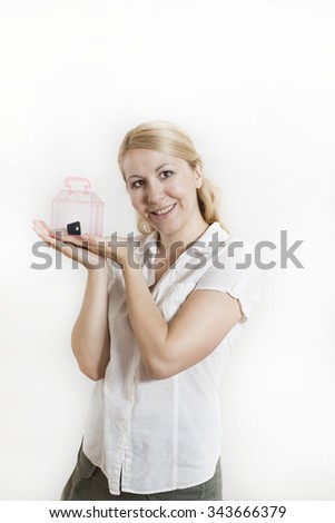 Young happy smiling business woman or real estate agent showing keys from new house