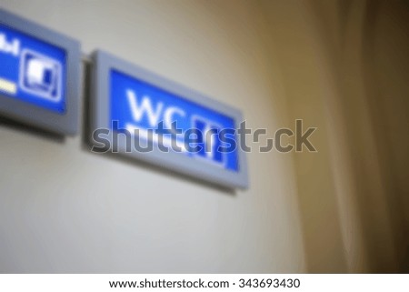Blurred water closet blue sign