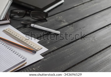 Office desk with business objects - open notebook, tablet computer, glasses,  ruler,  pencil,  pen. Free space for text. Office workplace