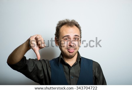 young business man showing thumbs down, manager office concept, shot isolated on gray background