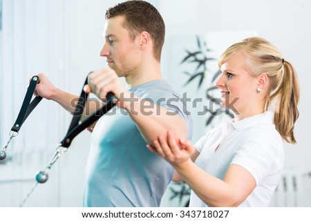 Patient at the physiotherapy doing physical exercises with Bowden cable  Royalty-Free Stock Photo #343718027