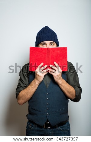 young business man with books, winter style clothes, studio shot isolated on the gray background, studio shot isolated on the gray background