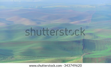 Palouse rolling hills in sunrise. The view from top of Steptoe Butte State Park. Natural landscape background