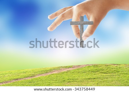 hand took the cross pin down the grass.