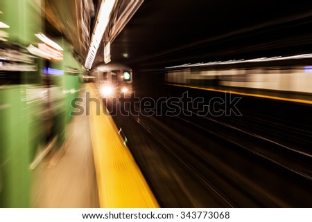 picture with creative zoom effect of a subway train at a subway station in NYC