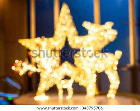 blurred yellow color of star and deer bokeh background.