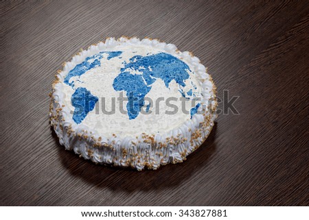 Large round cake with a picture of the World