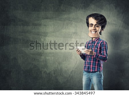 Funny bigheaded student with tablet on chalkboard background