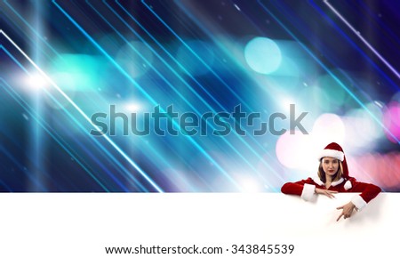Attractive Santa woman with white blank banner. Place your text