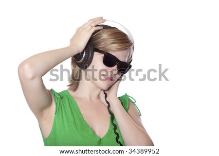 beautiful girl in a green dress and vintage sunglasses listening to music with big headphones, isolated on white