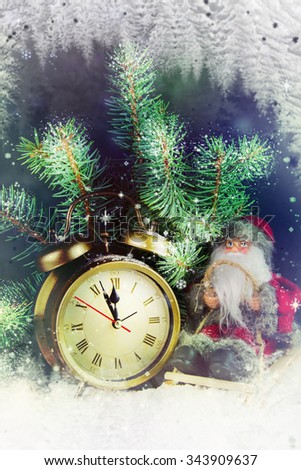 Christmas clock with toy Santa Claus.