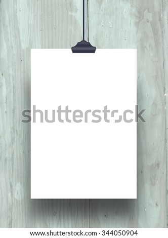 Vertical paper sheet frame with clip on cyan wooden boards background