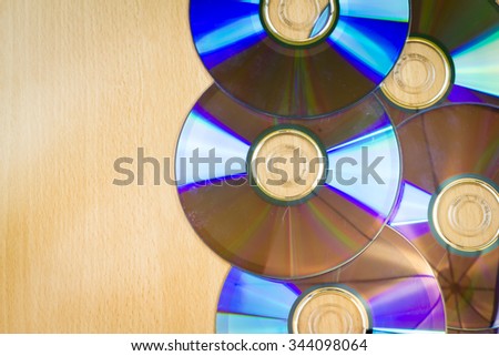 Five CDs on the wooden table / background texture