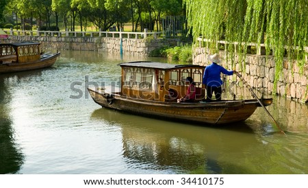The view of water town in China, with boat man rowing on river