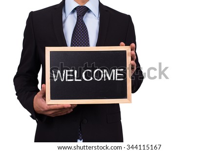 Businessman holding mini blackboard with WELCOME message
