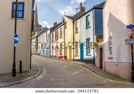 Deserted Cobbled Street Lined with Pastel Terraced Houses in Wales