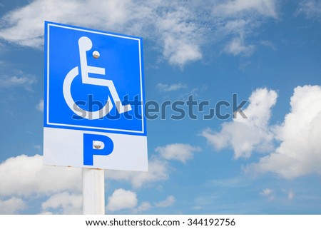 Handicapped parking place sign over blue sky.