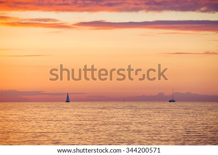Amazing gold orange sky and water at sunset over Baltic sea