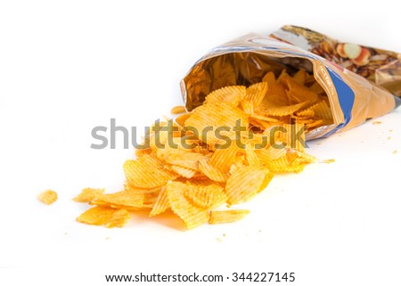 Potato crisp packet opened with crisps spilling out Royalty-Free Stock Photo #344227145