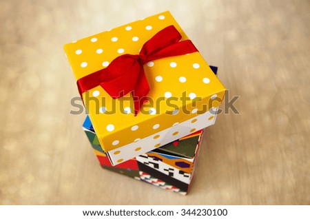 Two gift boxes with red ribbon bow