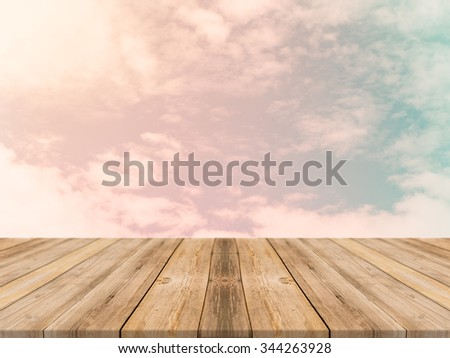 Vintage wooden board empty table in front of sky background. Perspective wood floor over sky - can be used for display or montage your products. Vintage filter.