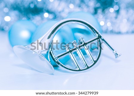 Silver trumpet with blue balls on background.Silver and blue Christmas ornaments. Xmas theme and New year theme for your text and design.