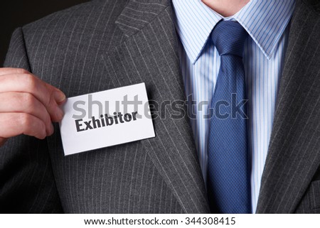 Businessman Attaching Exhibitor Badge To Jacket Royalty-Free Stock Photo #344308415