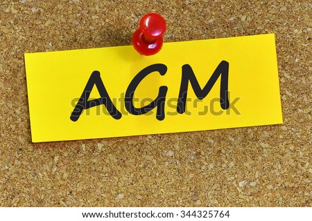 AGM word on yellow notepaper with cork background. Royalty-Free Stock Photo #344325764