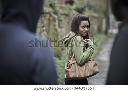 Teenage Girl Feeling Intimidated As She Walks Home Royalty-Free Stock Photo #344337557