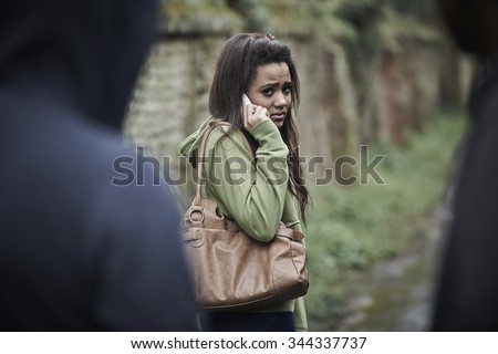 Teenage Girl Feeling Intimidated As She Walks Home Royalty-Free Stock Photo #344337737