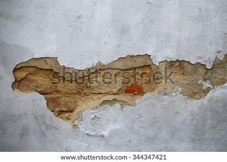 Photo closeup of shabby damaged red brick wall with peeled old chipped flaked gray plaster cover outdoor on concrete mural background, horizontal picture