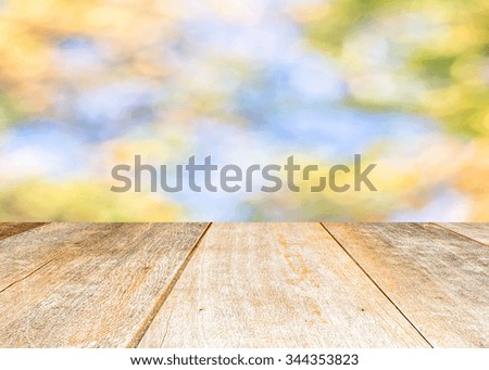 Top view of Wooden table with colorful  burred nature and  bokeh background