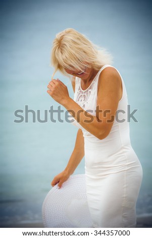 Happy woman in a dress on the beach