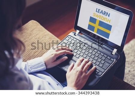 Woman learning Swedish through internet with a laptop at home