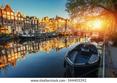 Amsterdam canal at sunset. Amsterdam is the capital and most populous city in Netherlands.  Royalty-Free Stock Photo #344403392